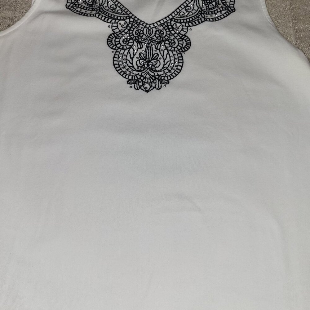 White sleeveless top with Black Design around neckline
